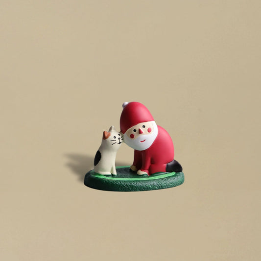 Santa Claus and a black cat touching faces affectionately, cute and heartwarming Christmas decoration.