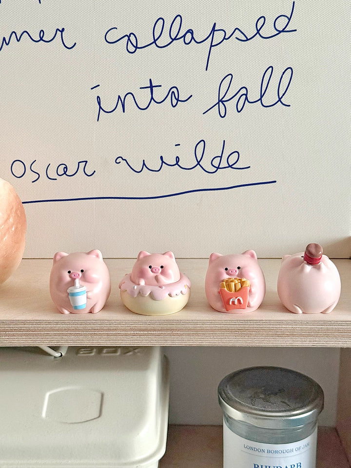 Four adorable piggy figurines with playful expressions, perfect for brightening up your desktop.