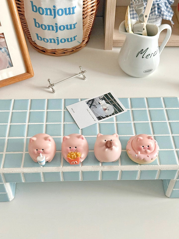 Four adorable piggy figurines with playful expressions, perfect for brightening up your desktop.