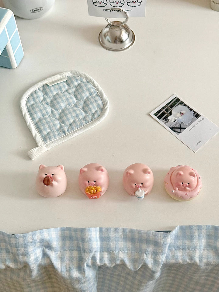Four adorable piggy figurines with playful expressions, perfect for brightening up your desktop.
