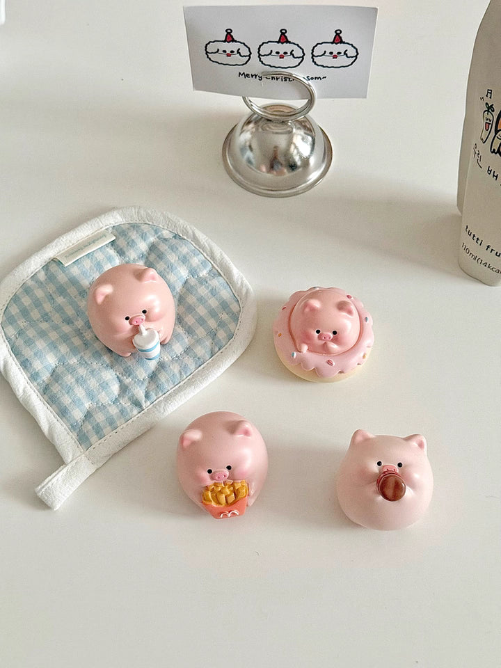Four adorable piggy figurines with playful expressions, perfect for brightening up your desktop.