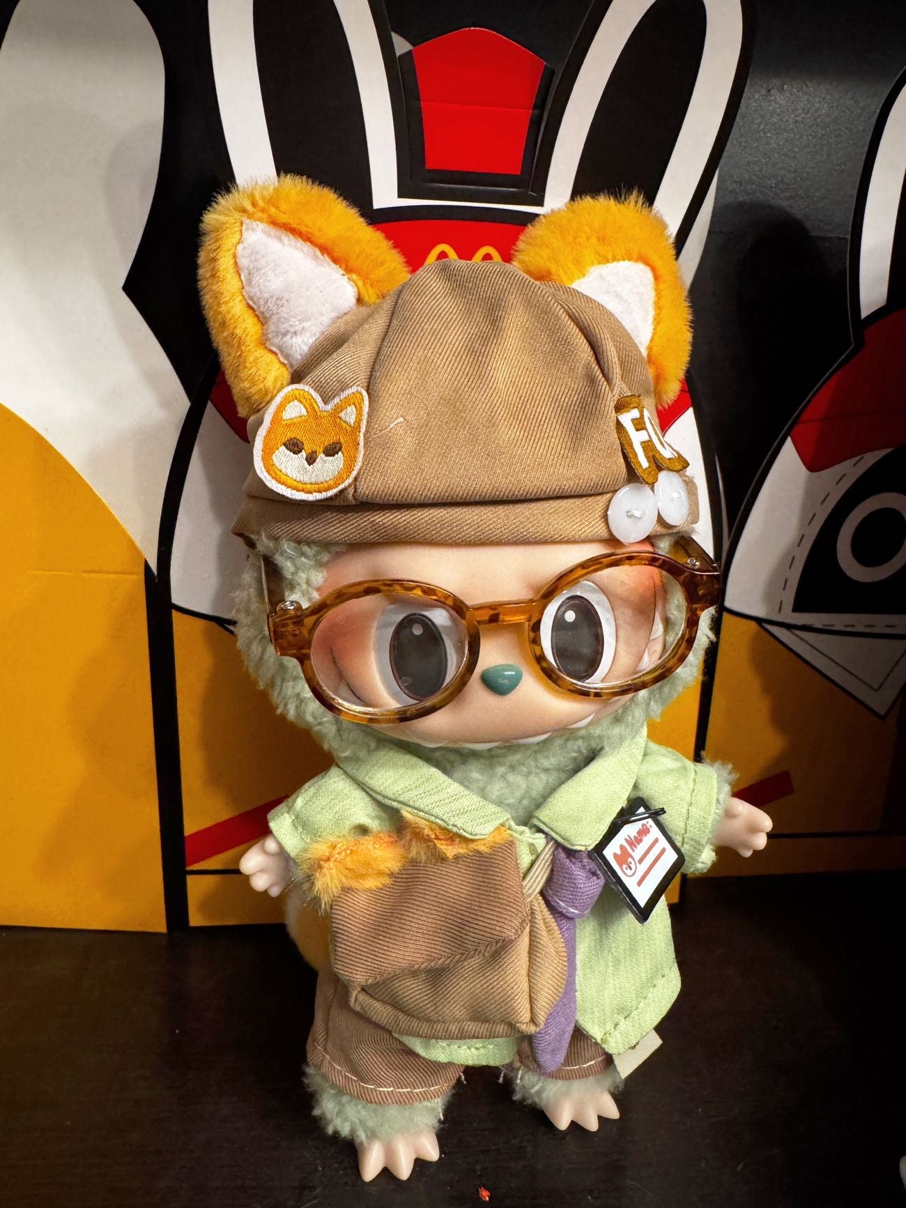 Labubu dressed as an office fox wearing a tie and work outfit