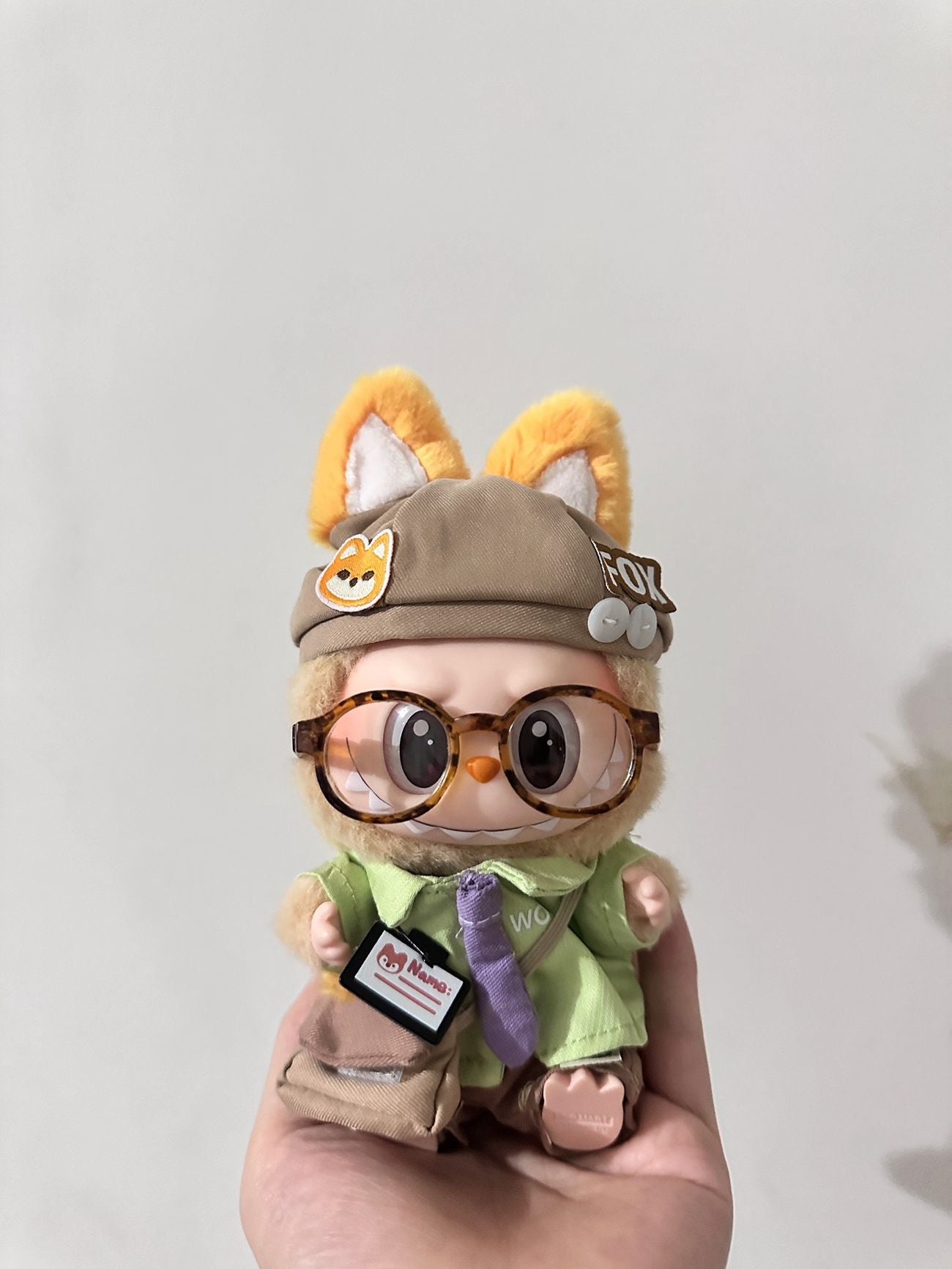 Labubu dressed as an office fox wearing a tie and work outfit