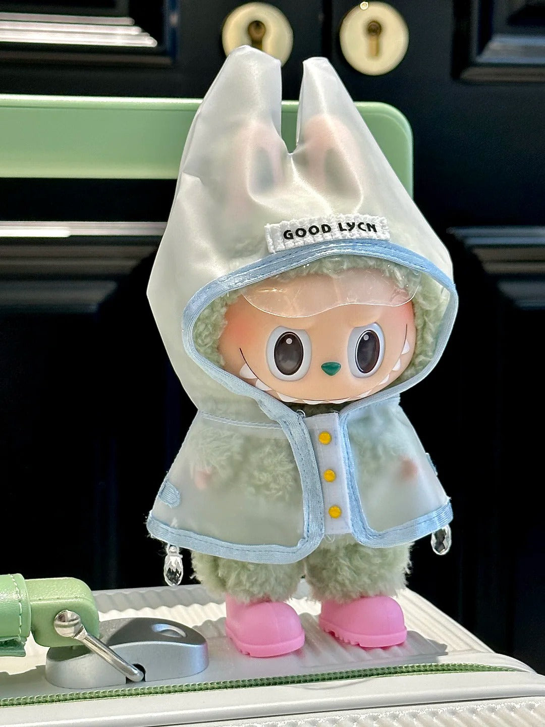 Labubu wearing an adorable raincoat on a rainy day