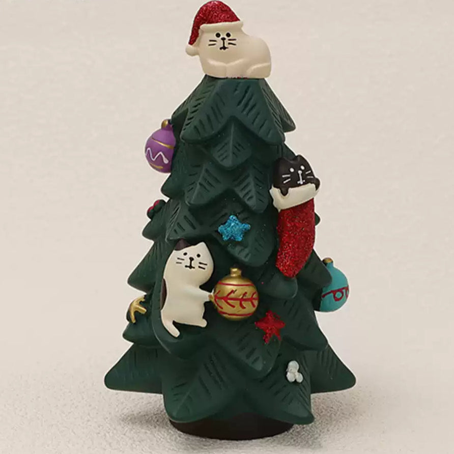 Cute kittens climbing up a festive Christmas tree.