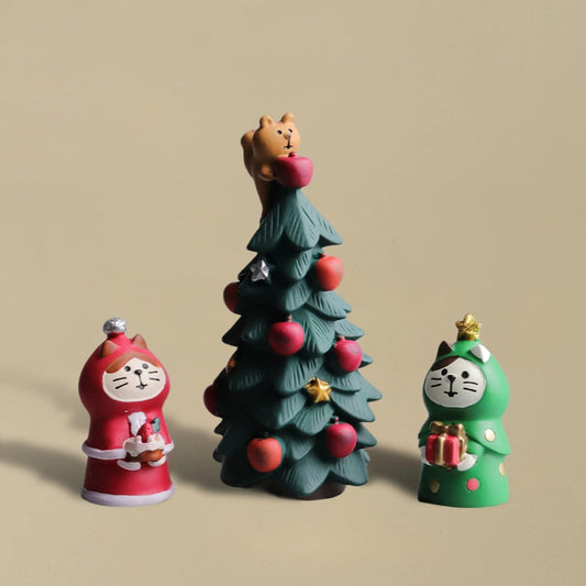 A small pinecone-style Christmas tree with apples