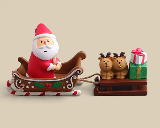 Santa Claus sitting in a sleigh with reindeer and gifts